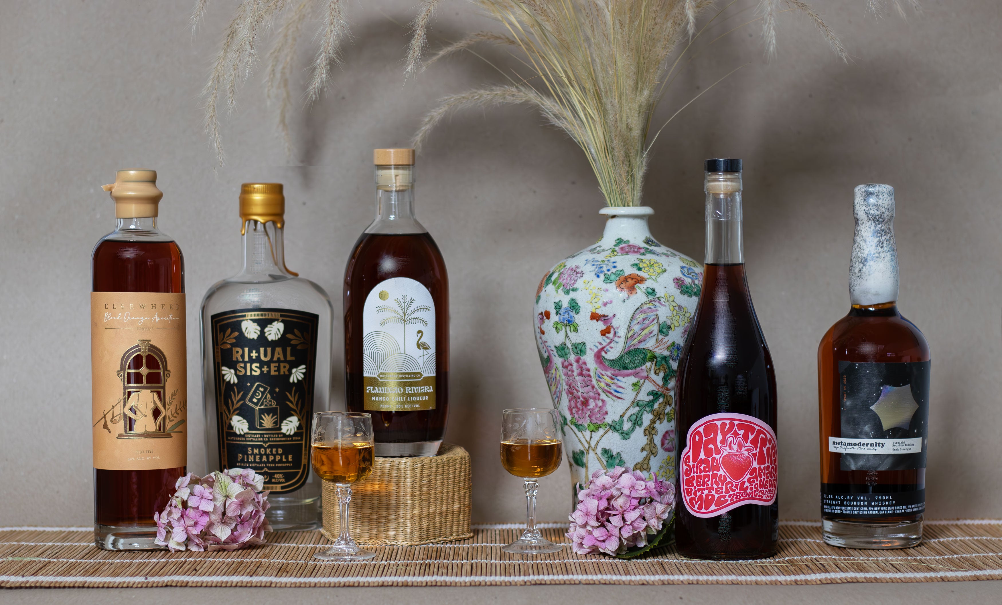 Collection of alcohol bottles on a shelf with decorative elements