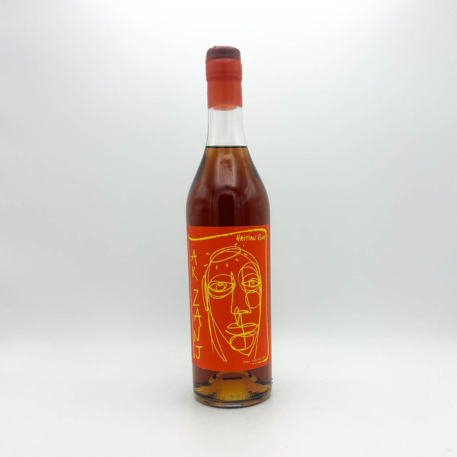 Bottle of alcohol with a red label featuring a face design on a white background