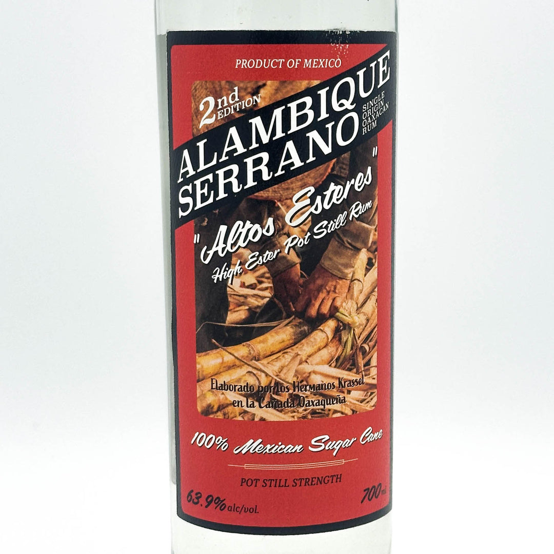 Alambique Serrano tequila bottle with red label on a white background