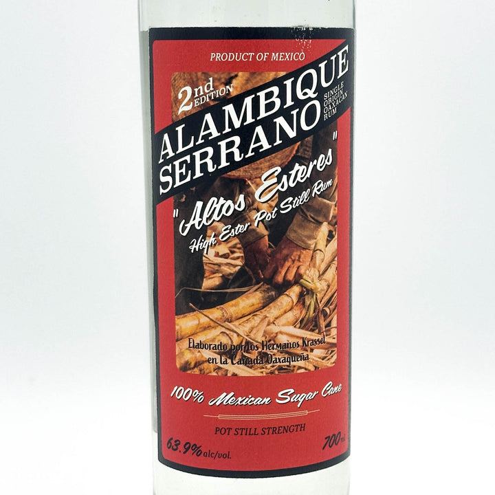 Alambique Serrano tequila bottle with red label on a white background