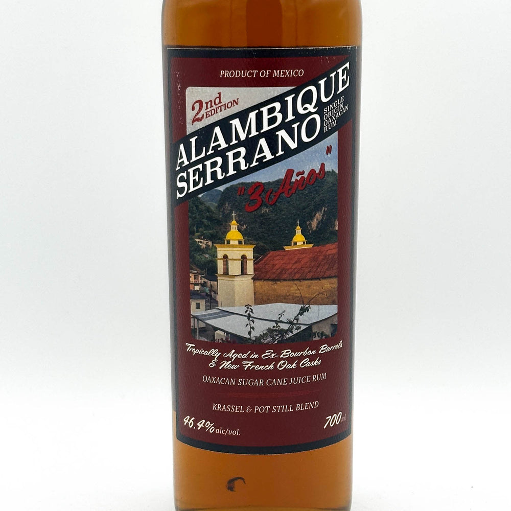 Alambique Serrano rum bottle with label on a white background