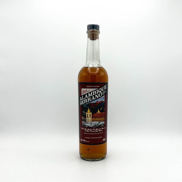 Bottle of Alambique Serrano rum on a white background