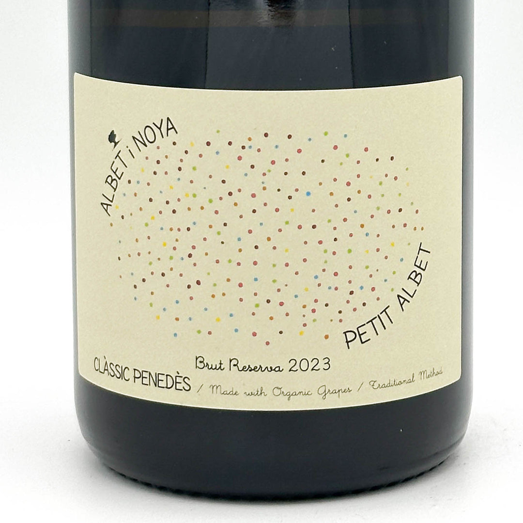 Wine bottle with a label featuring colorful dots and text on a white background