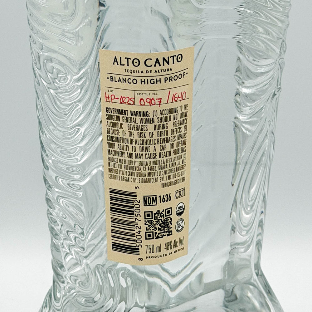 Clear glass bottle with 'Alto Canto' label on a white background