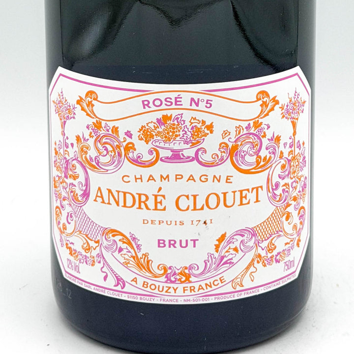 Bottle of André Clouet Champagne with decorative label on a white background
