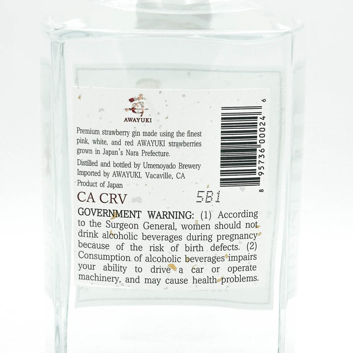 The back label of a clear glass bottle of AWAYUKI CA CRV premium strawberry gin, showing product details, a barcode, and a government warning on a white background.