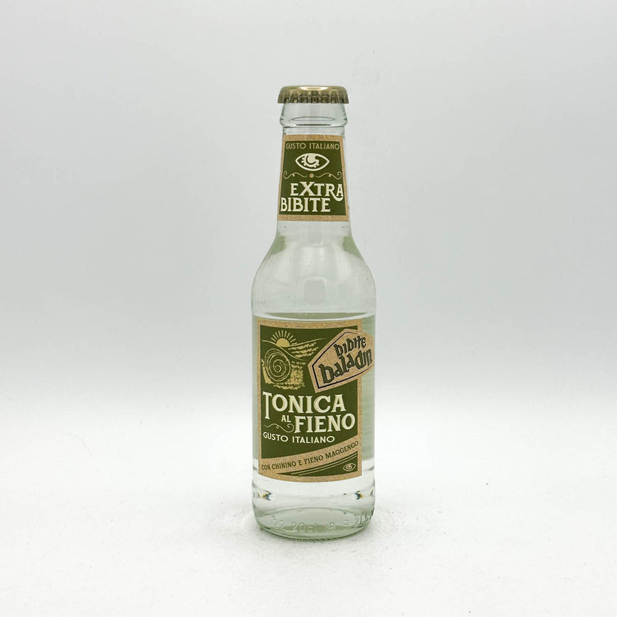 Clear glass bottle with green label on a white background