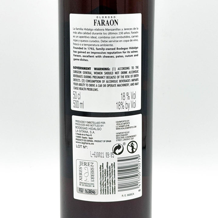 The back of a dark bottle of Faraon brand liquor, showing the white label with product details, warnings, and a barcode on a light gray background.