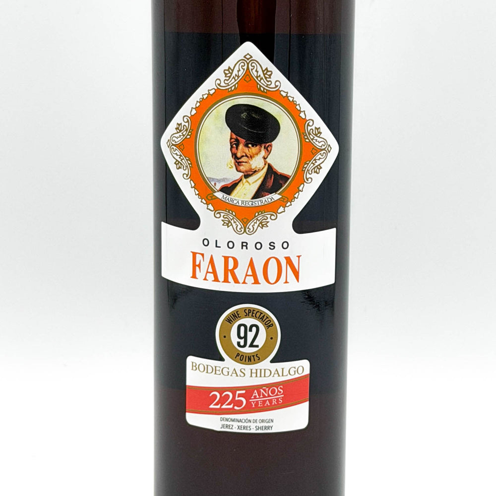 A bottle of Oloroso Faraon aged sherry from Bodegas Hidalgo, featuring a dark glass bottle with a detailed vintage-style label showing a portrait and orange, white, and red text.
