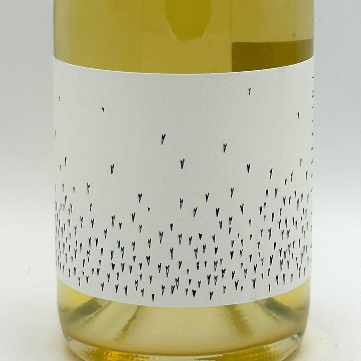 Wine bottle with a white label featuring black patterns on a light gray background