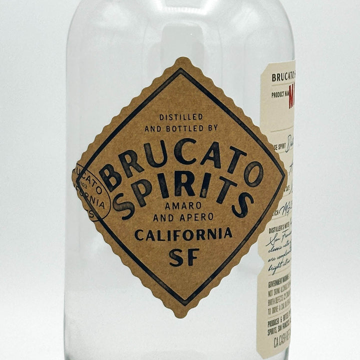 Brucato Spirits bottle with a brown label on a white background