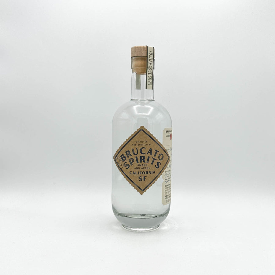 Clear glass bottle with wooden cork cap on a white background