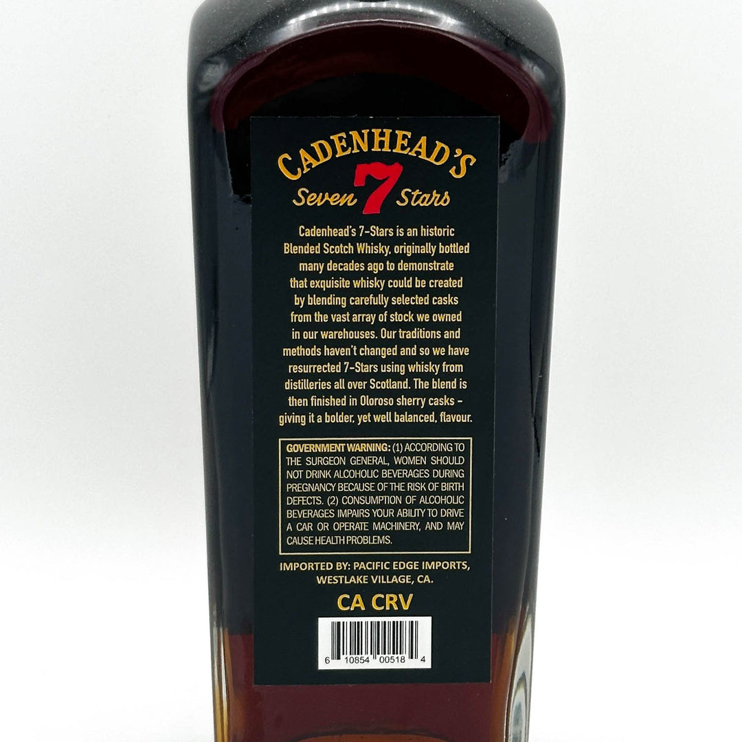 Bottle of Cadenhead's Seven Stars whisky with label on a white background