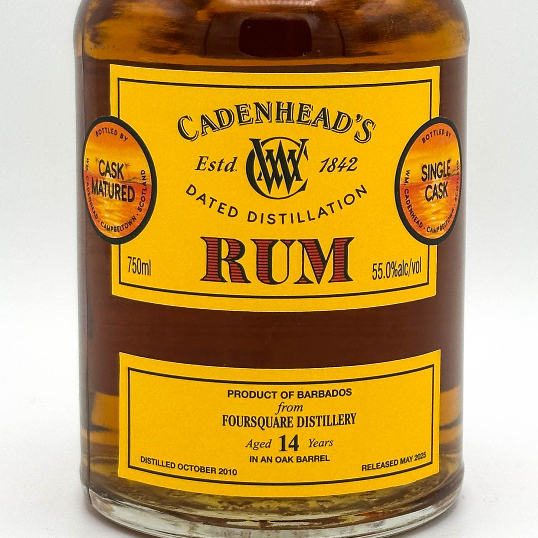 Bottle of Cadenhead's Rum with a yellow label on a white background