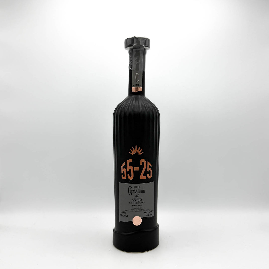 Black bottle with a cork stopper on a white background