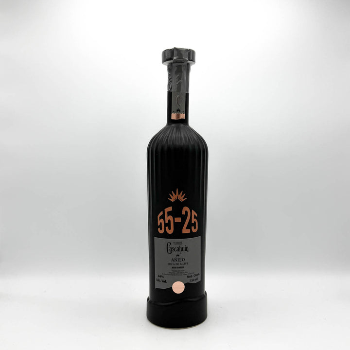 Black bottle with a cork stopper on a white background