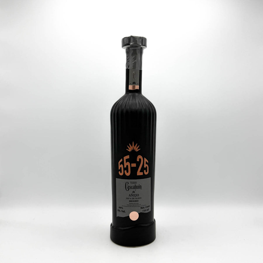 Black bottle with a cork stopper on a white background