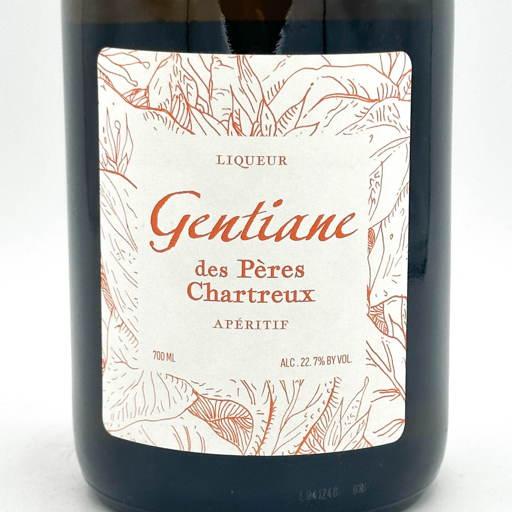Bottle of Liqueur Gentiane des Pères Chartreux with a decorative label on a white background