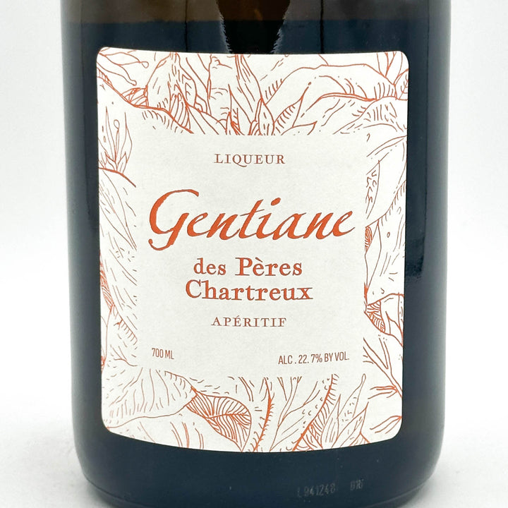 Bottle of Liqueur Gentiane des Pères Chartreux with a decorative label on a white background