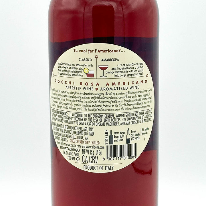 Red bottle with a label on a white background