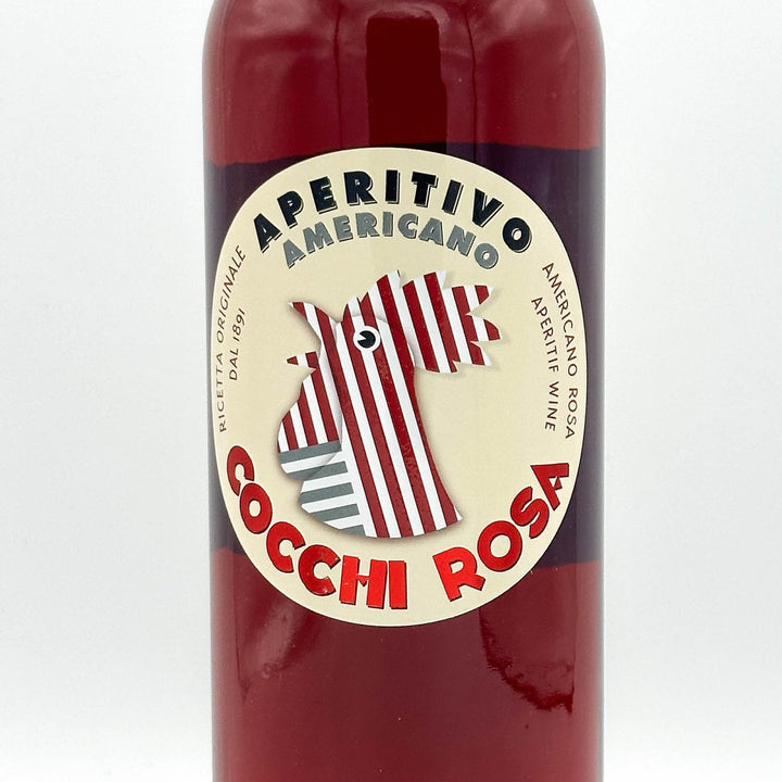 Red bottle of Aperitivo Americano Cocchi Rosa with a label featuring a horse design on a white background.