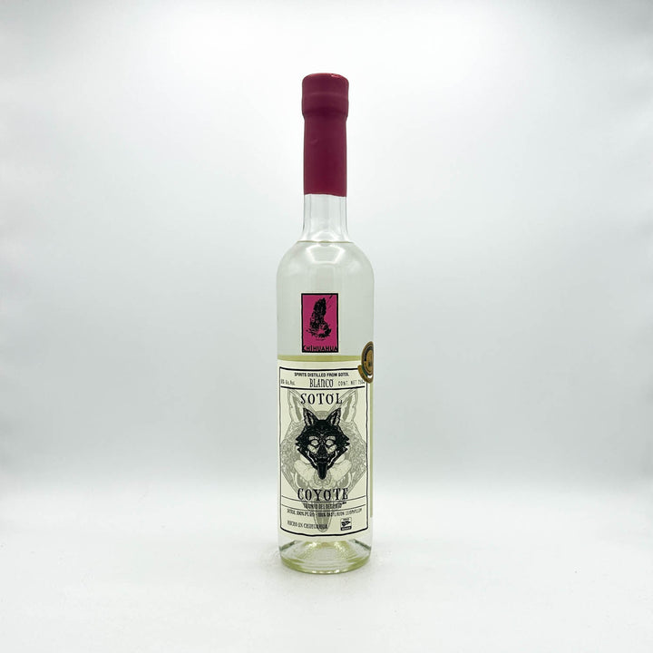 Sotol bottle with a red cap on a white background