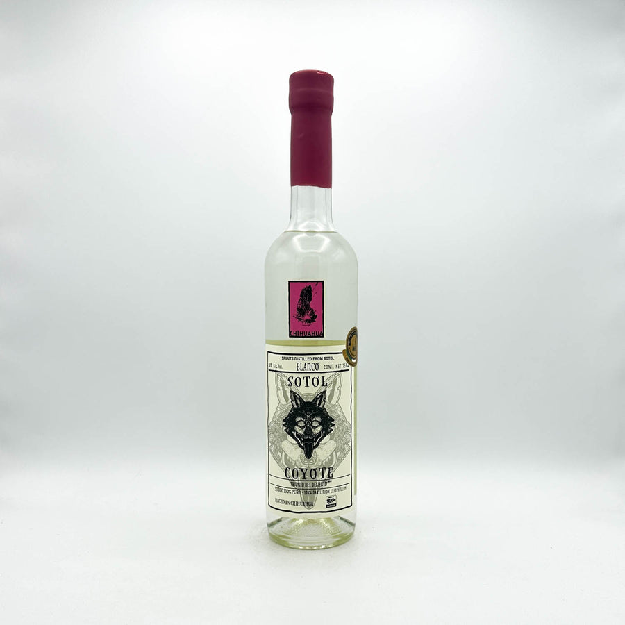 Sotol bottle with a red cap on a white background