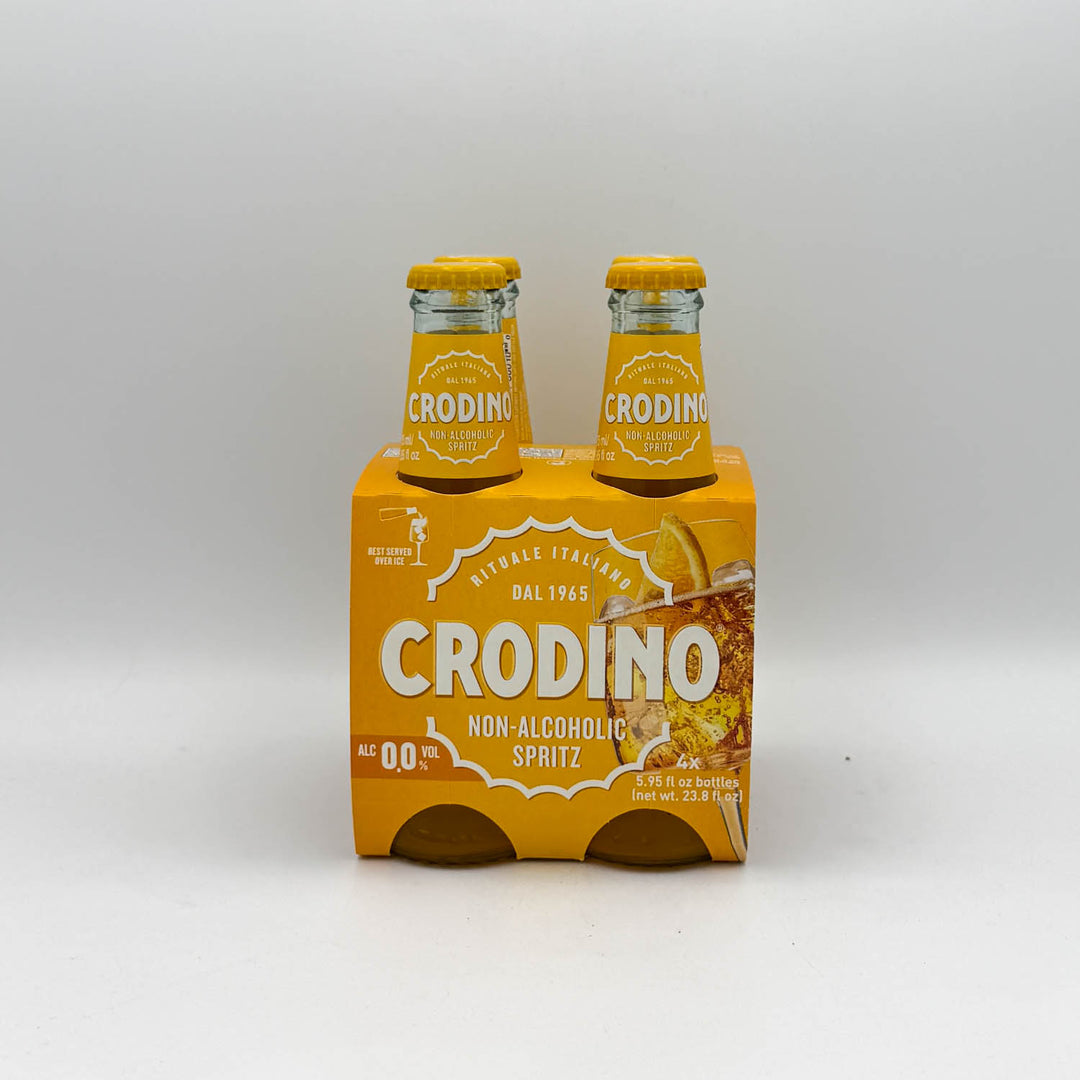 Four bottles of Crodino non-alcoholic spritz in a yellow box on a white background