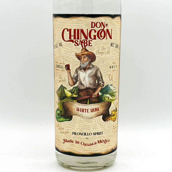 Bottle of Don Chingon Sabe White Rum with a label featuring a person in a cowboy hat and boots.