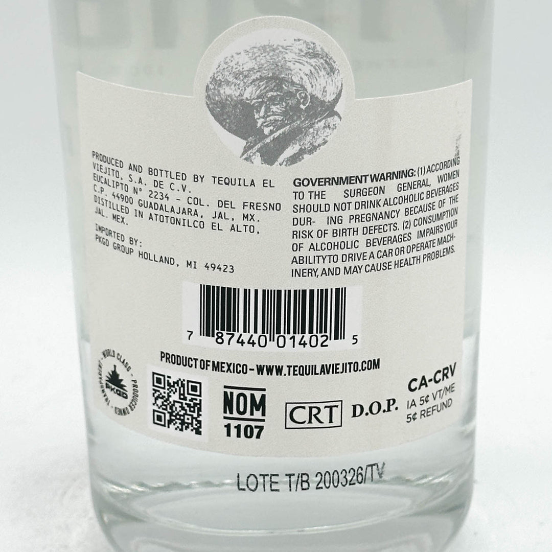 Close-up of a tequila bottle label with text and barcodes on a white background