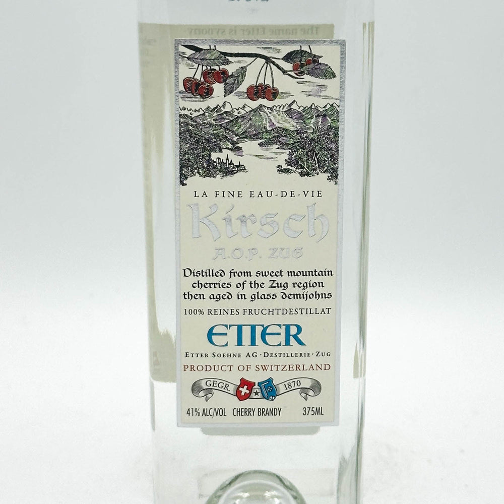 Kirsch brandy bottle with decorative label on a white background