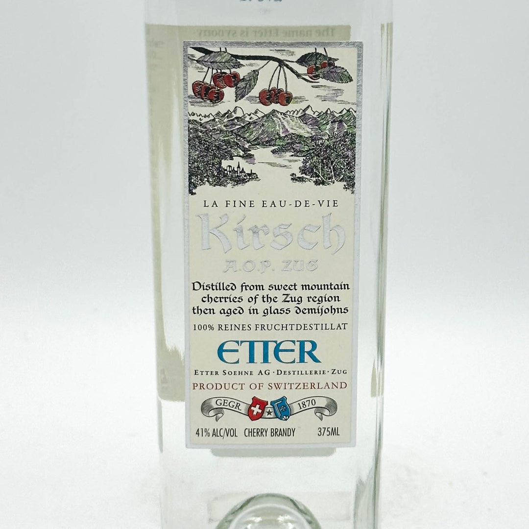 Kirsch brandy bottle with decorative label on a white background