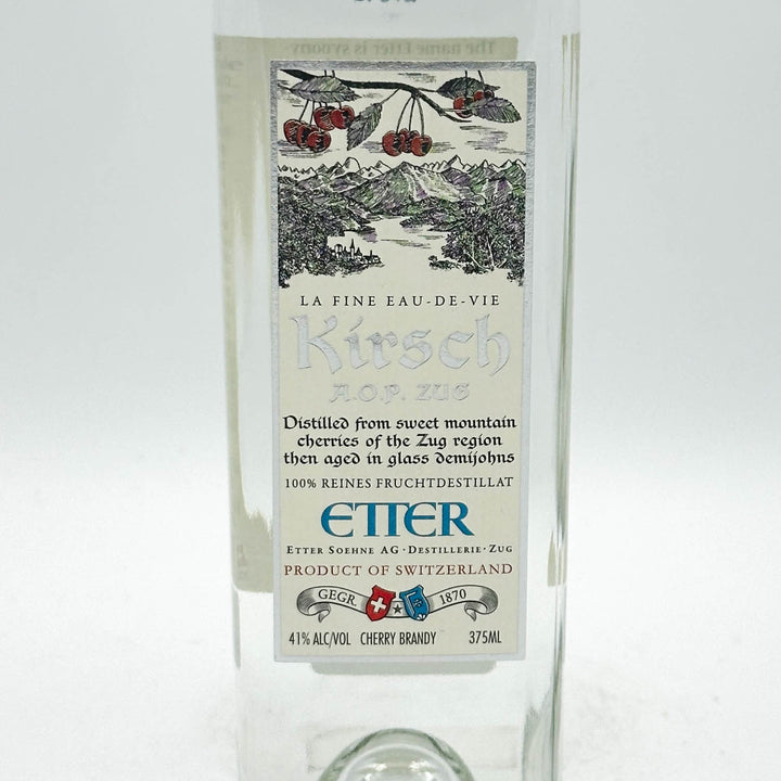 Kirsch brandy bottle with decorative label on a white background