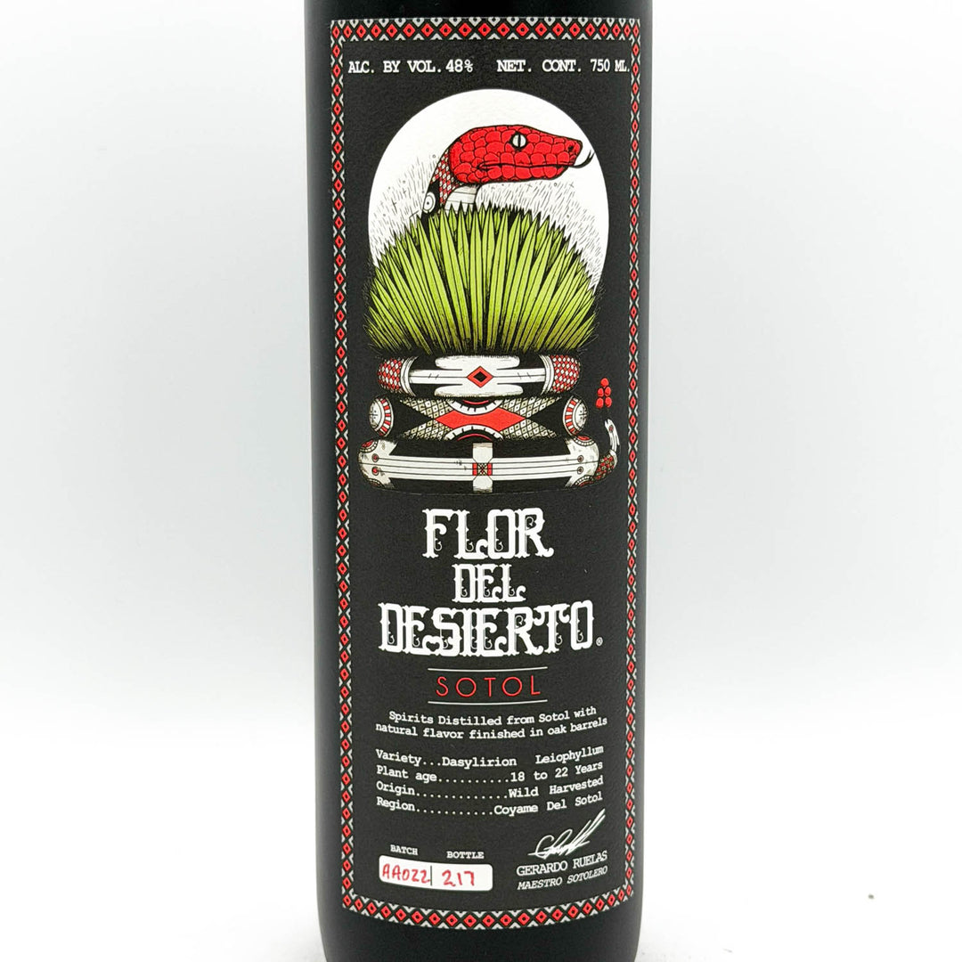 Sotol bottle with decorative label featuring a red snake and green grass on a white background