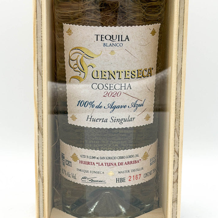 Tequila bottle with a label in a wooden box