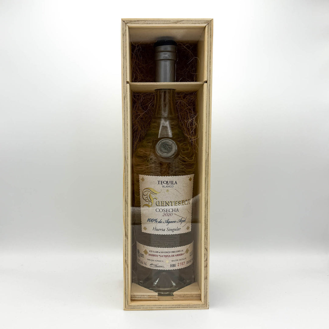 Tequila bottle in a wooden box on a white background