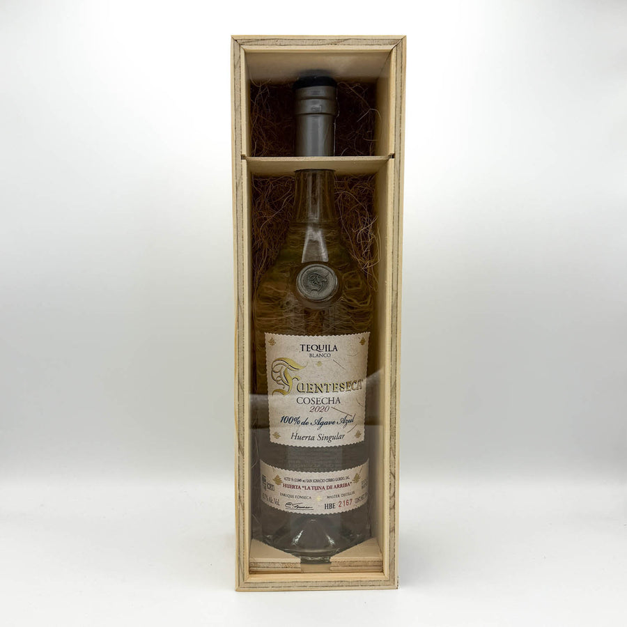 Tequila bottle in a wooden box on a white background