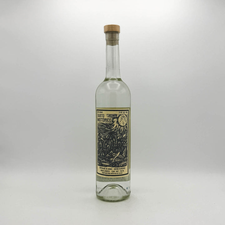 Clear glass bottle with a cork stopper on a white background