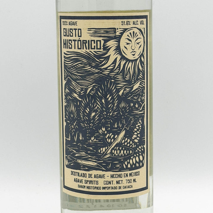 Bottle of Gusto Histórico agave spirit with decorative label on a white background