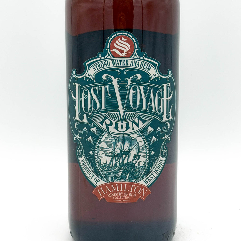 Bottle of Lost Voyage Rum with a decorative label on a white background