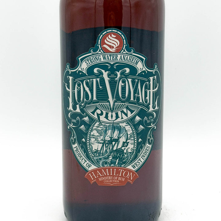 Bottle of Lost Voyage Rum with a decorative label on a white background