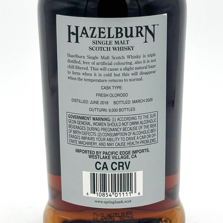 Close-up of the back label of a Hazelburn Single Malt Scotch Whisky bottle, showing product details, a barcode, and the CA CRV import code on a white background.