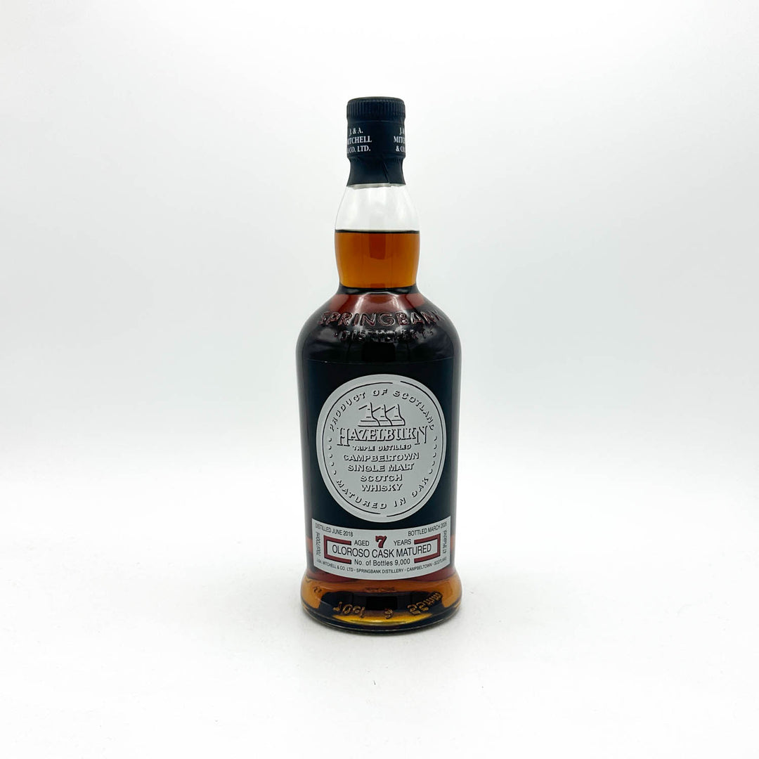 A bottle of 1970 Macallan Highball whisky on a clean white background. The dark glass bottle shows the amber-colored liquid inside, with a black cap and a prominent circular white label.