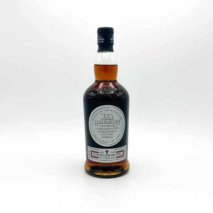 A bottle of 1970 Macallan Highball whisky on a clean white background. The dark glass bottle shows the amber-colored liquid inside, with a black cap and a prominent circular white label.