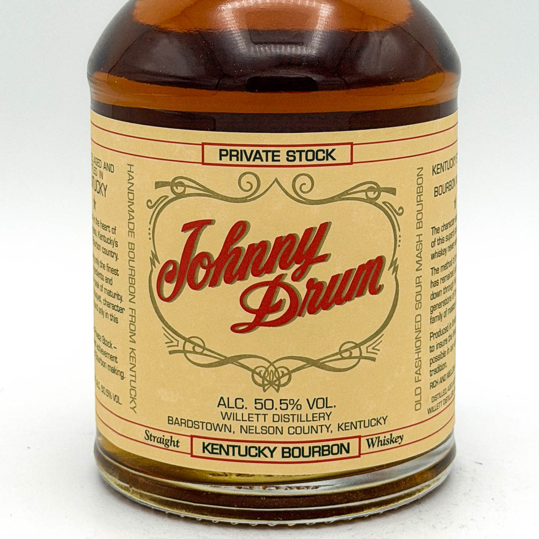 Johnny Drum whiskey bottle with label on a white background