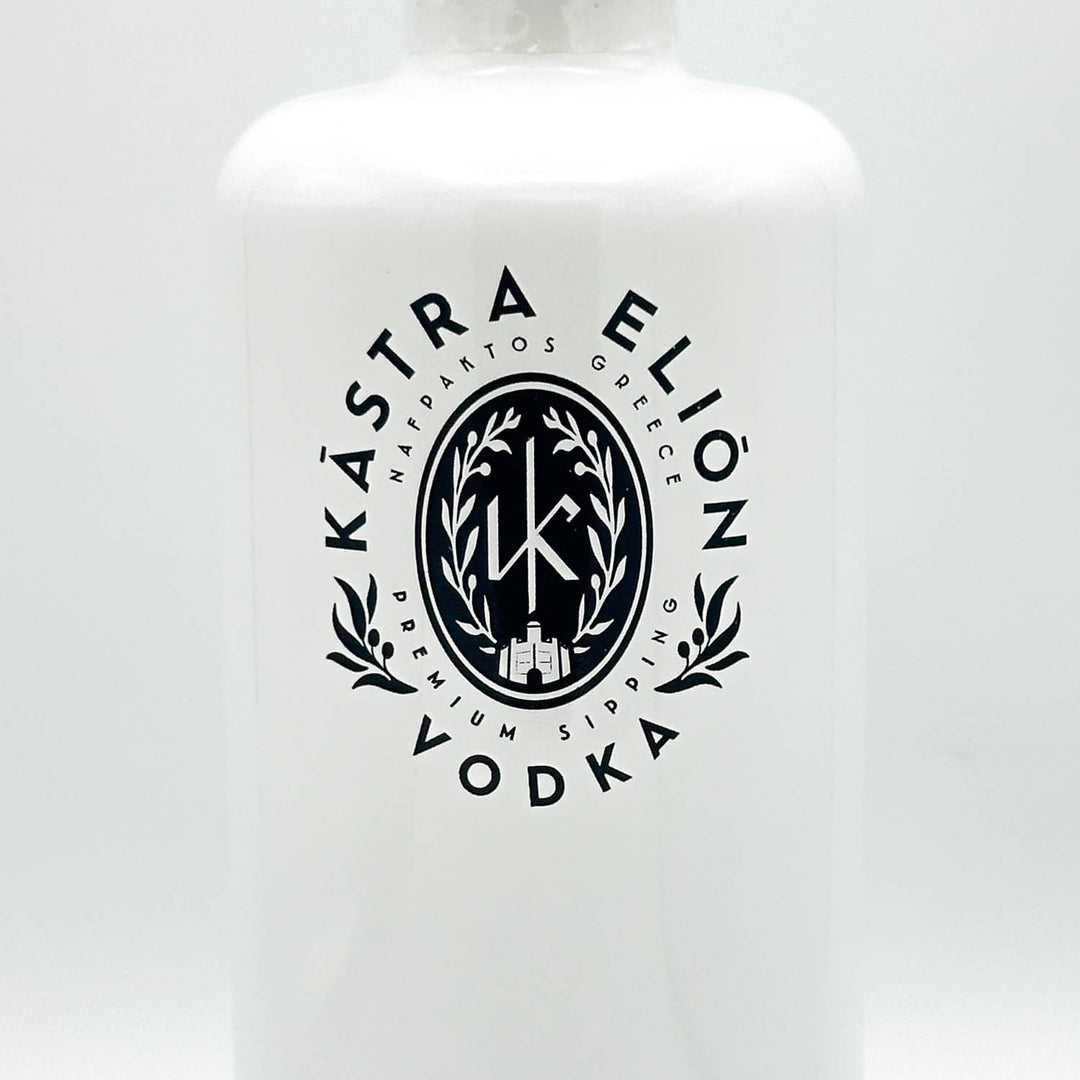 A white bottle of KĀstra Ellion Vodka with a prominent black circular logo on the front, set against a clean white background.