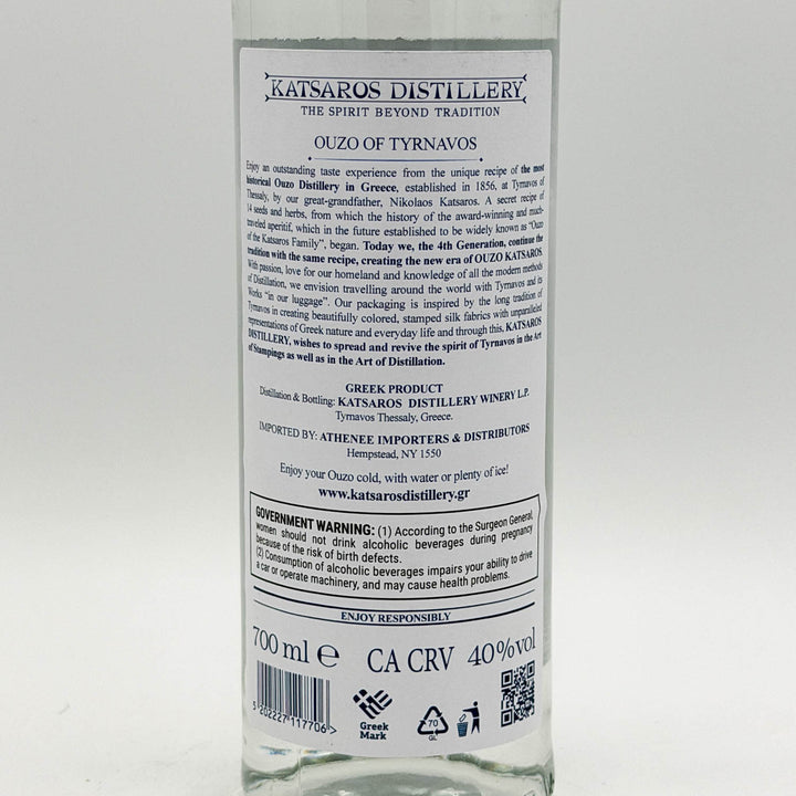 Back label of a Katsaros Distillery ouzo bottle on a white background