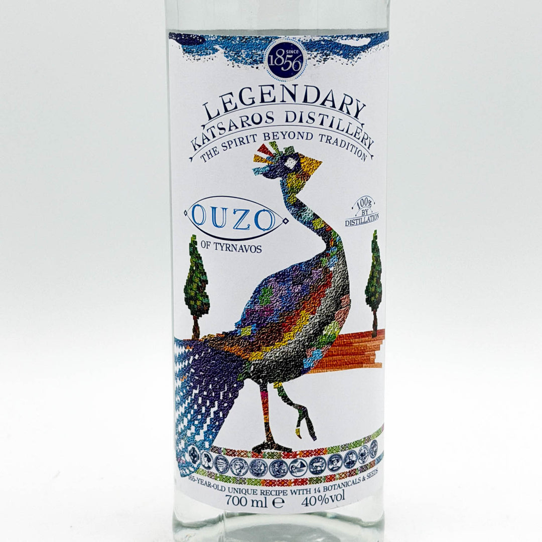 Ouzo bottle with colorful peacock design on a white background