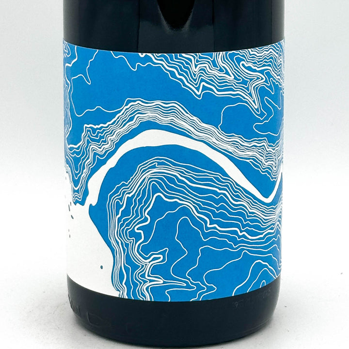 Wine bottle with blue and white label on a white background