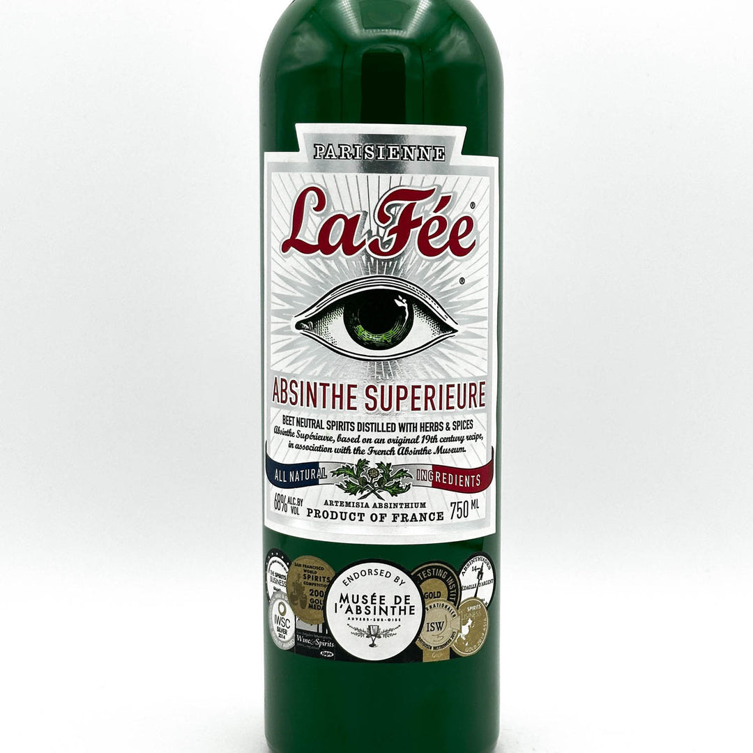 Green bottle of La Fée Absinthe Superieure with label on a white background